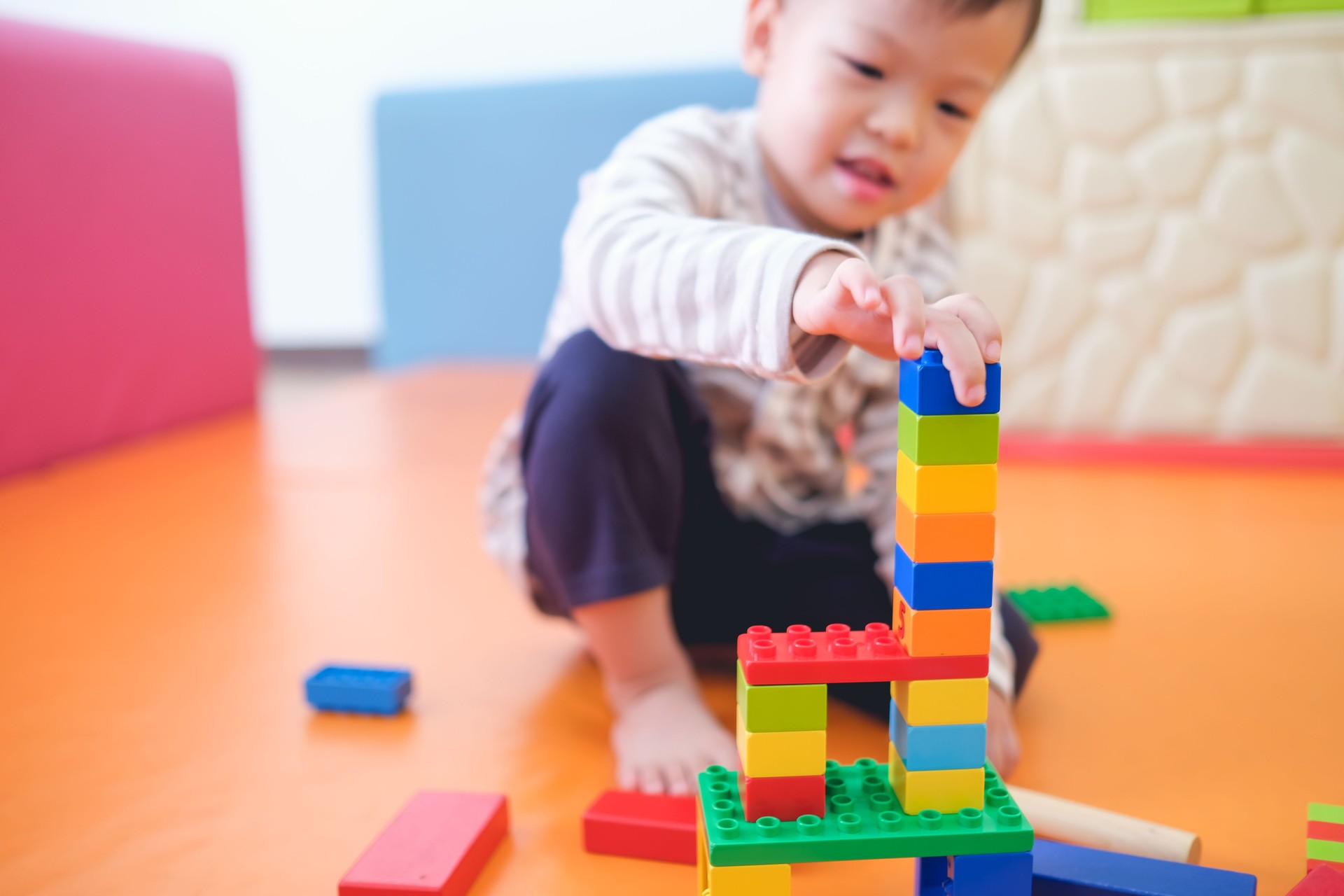 Cute little Asian 2 - 3 years old toddler boy child having fun playing with colorful plastic blocks indoor Cute little Asian 2 - 3 years old toddler boy child having fun playing with colorful plastic blocks indoor